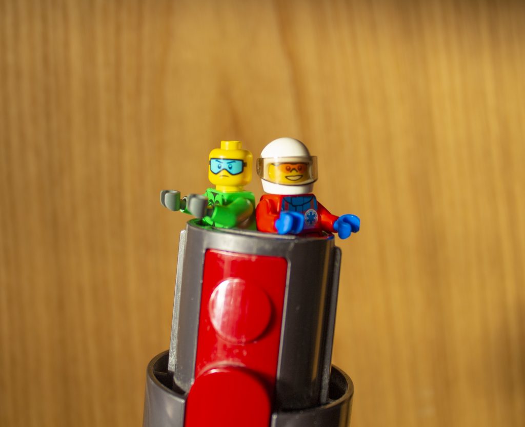 LEGO characters trying to escape a vacuum cleaner.