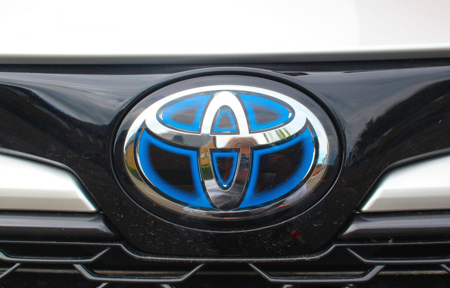 Badge and grille at front of car.