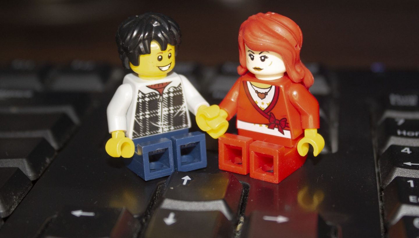 Lego couple sharing a home office.