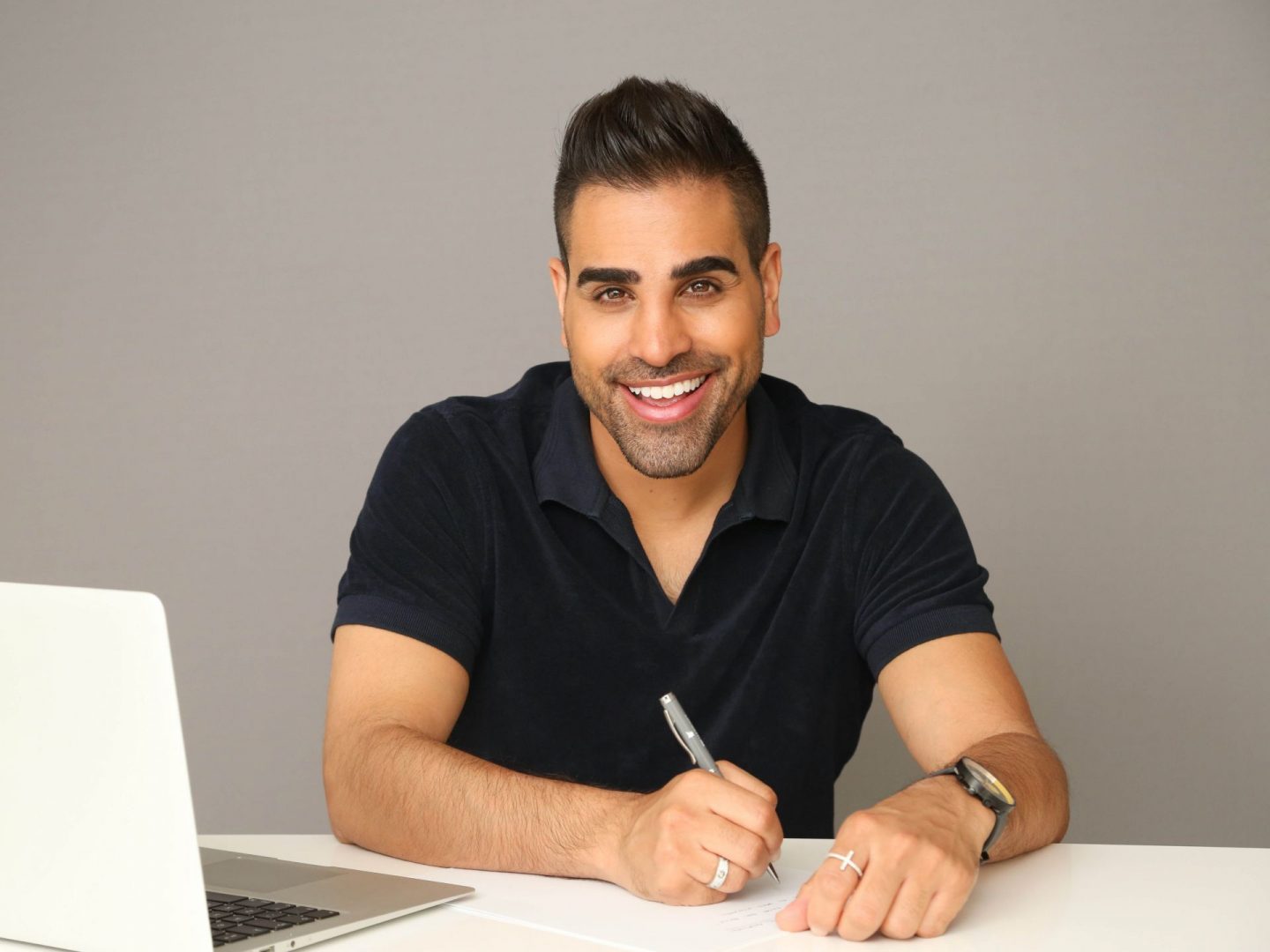 Dr Ranj sat at desk doing work.