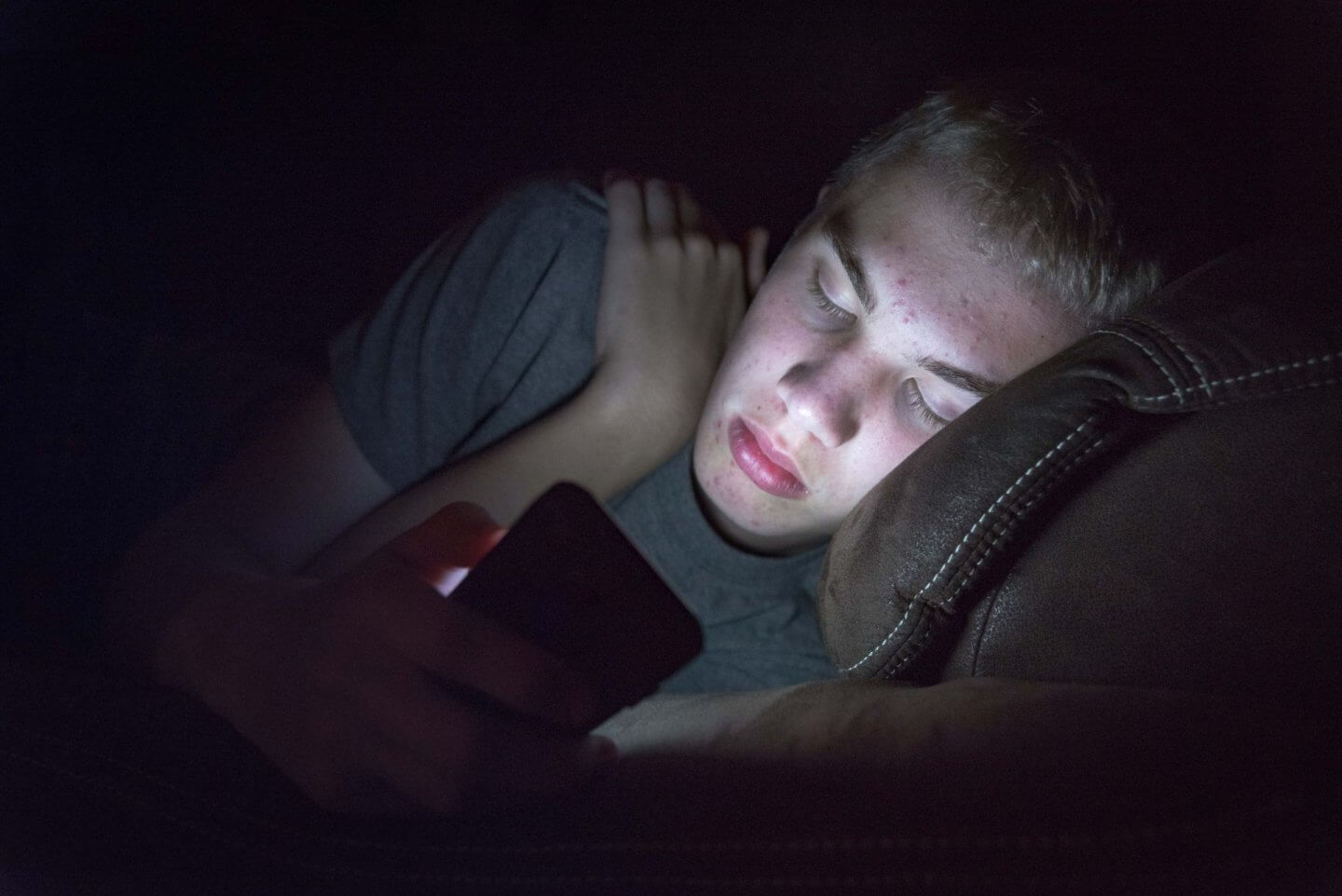 Teenager setting screen time rules on his phone